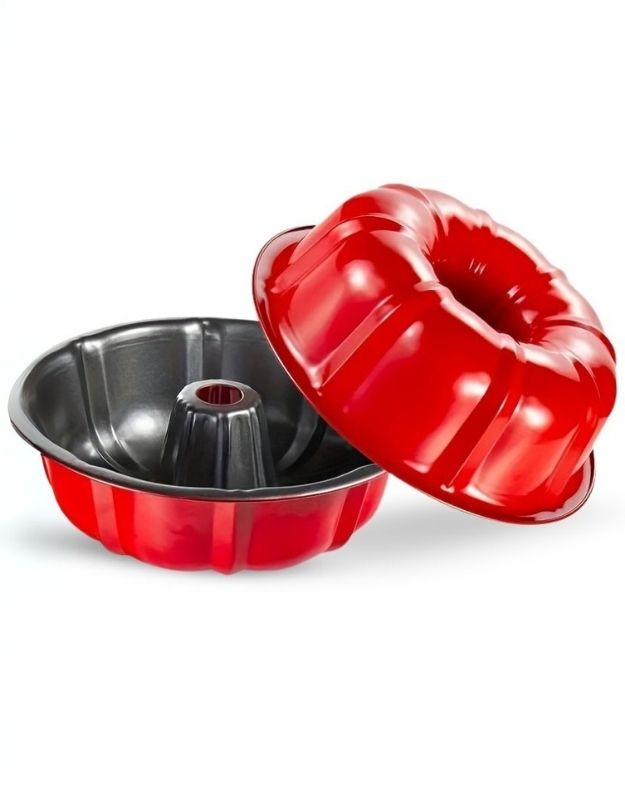 Red Bundt cake mold with a silver interior on a white background. Set of red Bundt cake pans with nonstick interior and fluted edges.